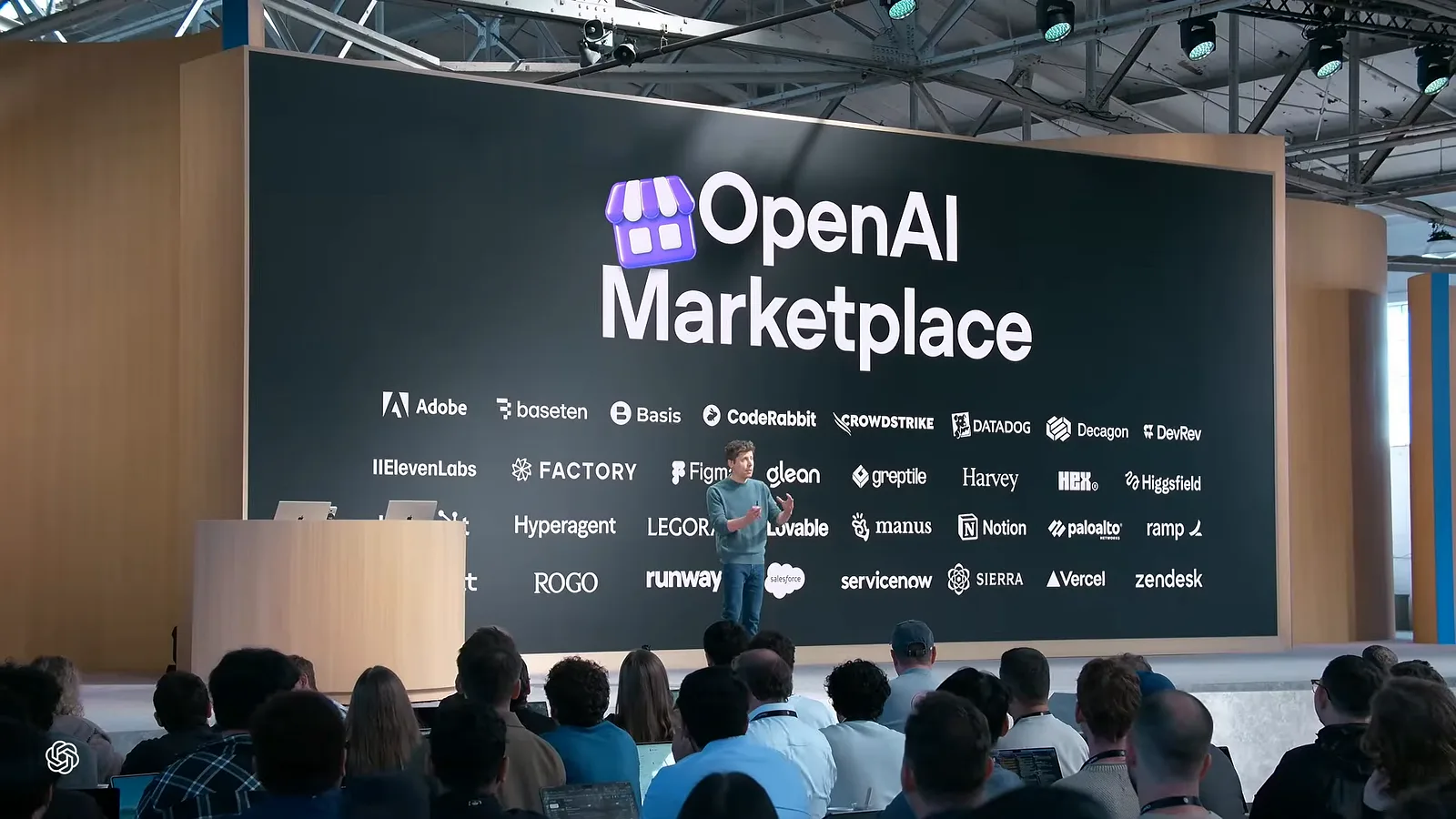 Sam Altman on stage at OpenAI DevDay 2026 in front of a large slide reading OpenAI Marketplace, with launch partner logos including Adobe, Figma, Notion, Salesforce and Vercel