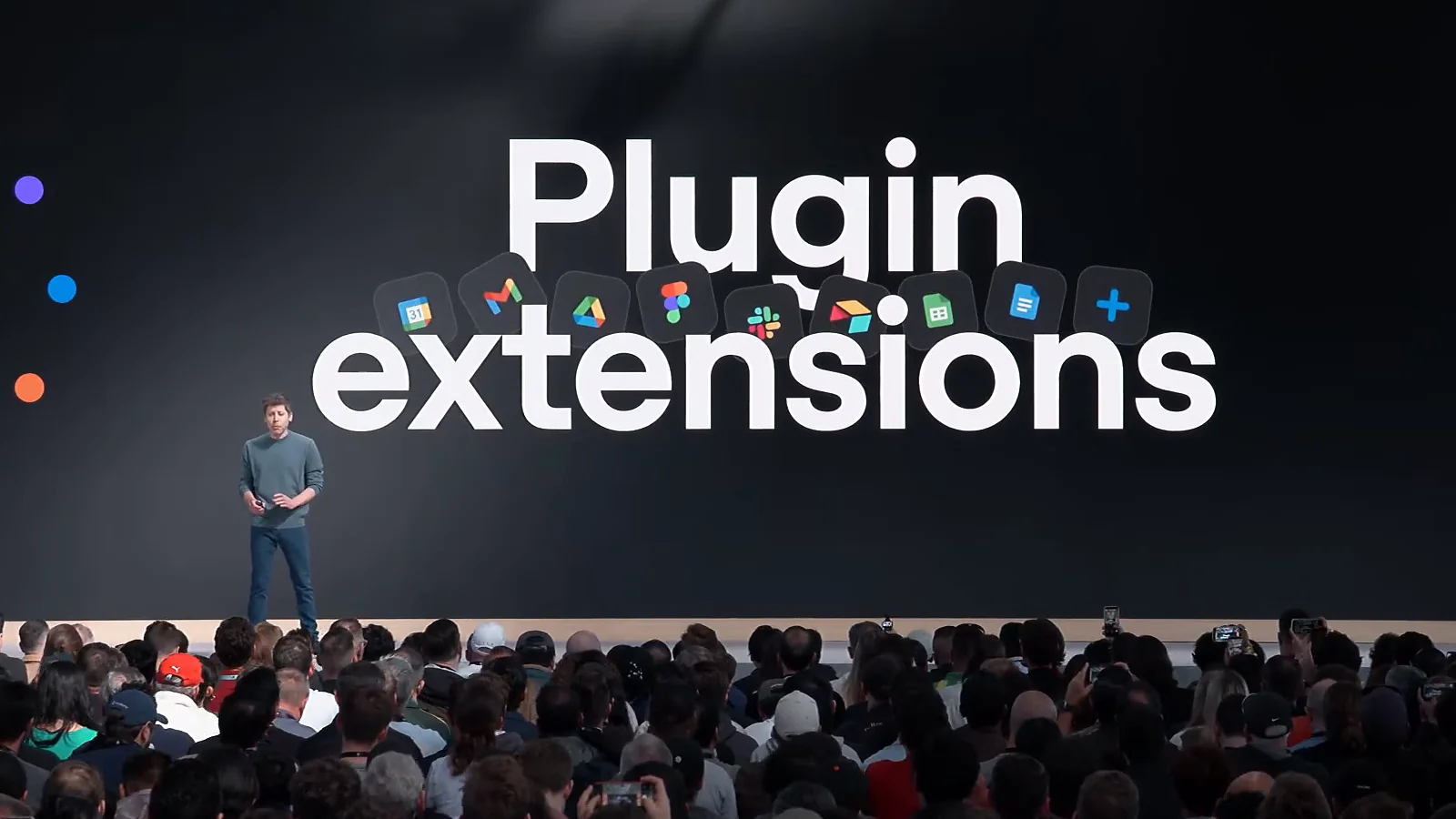 Sam Altman on stage at OpenAI DevDay 2026 in front of a large slide reading Plugin extensions, with app icons for Calendar, Gmail, Drive, Figma and Slack